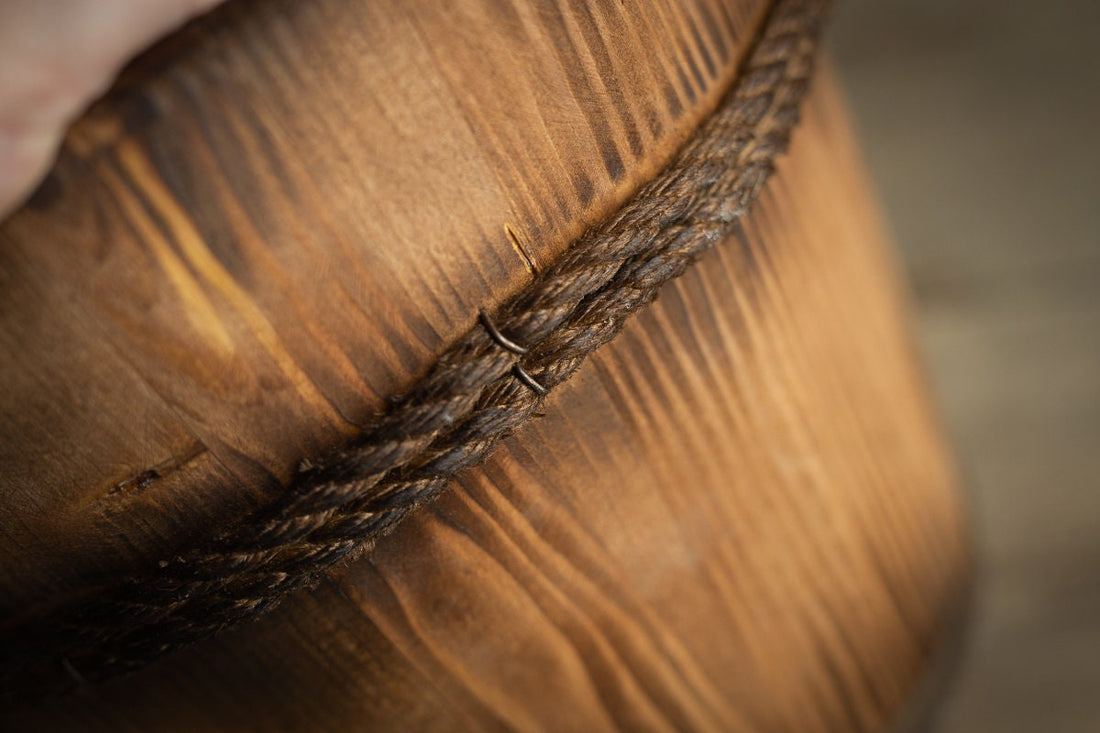 Carved wooden newborn bucket prop photographed in soft natural light