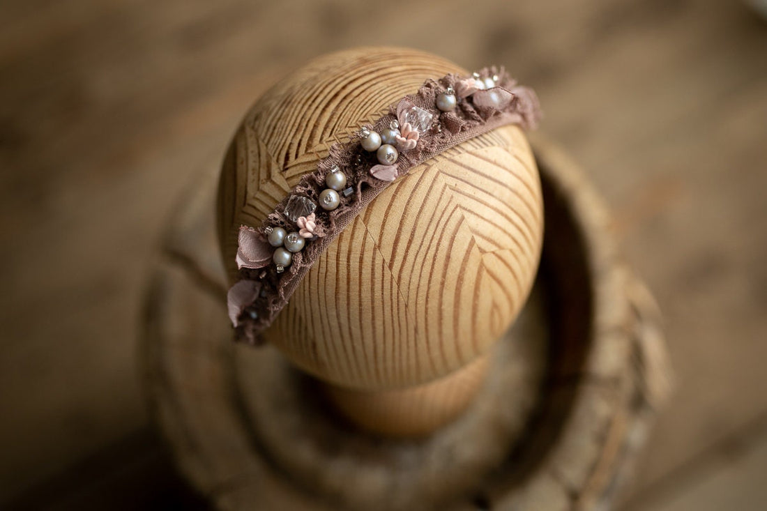 Soft newborn girl headband photography prop — perfect for a gentle, styled newborn session