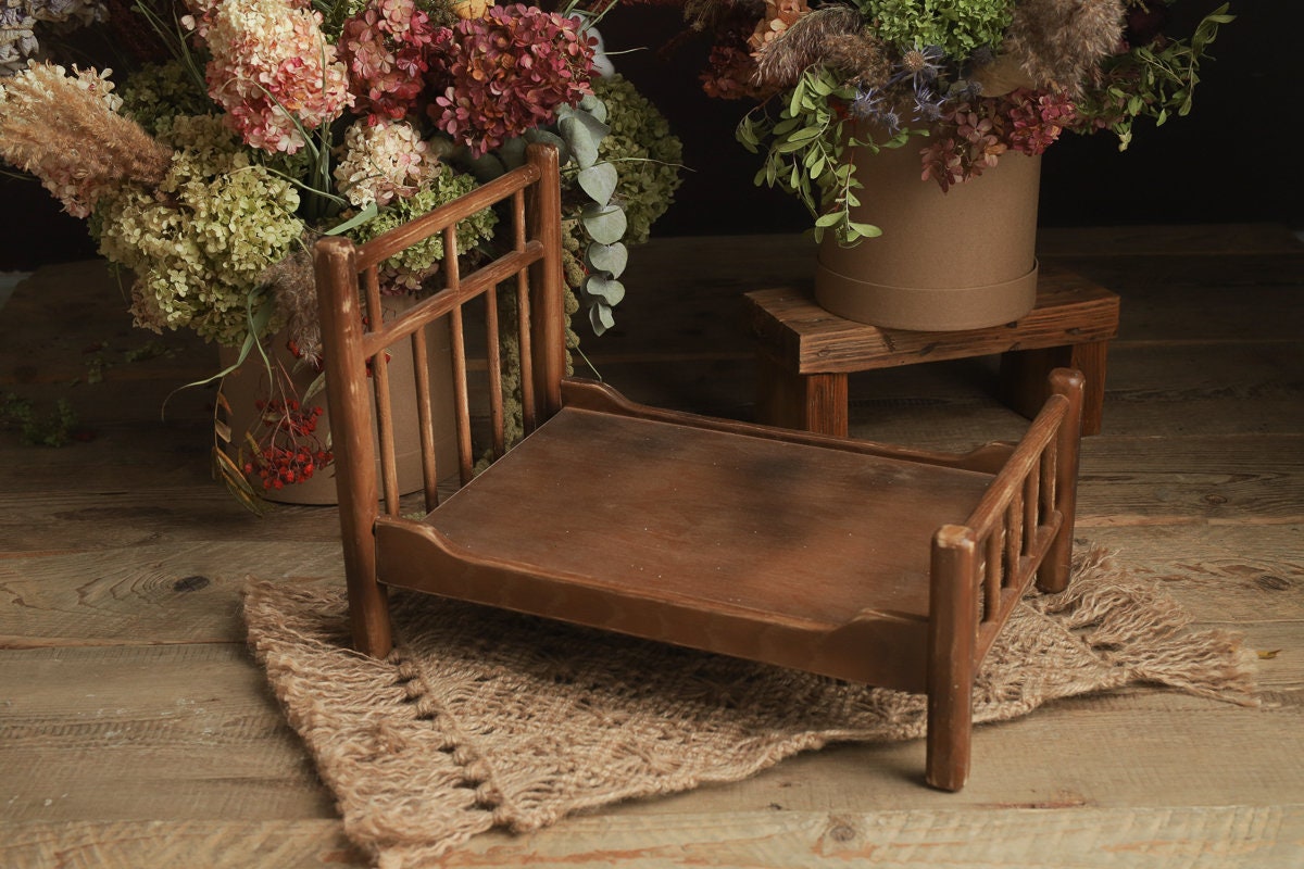 Rustic wooden crib prop styled for a calm newborn photography portrait