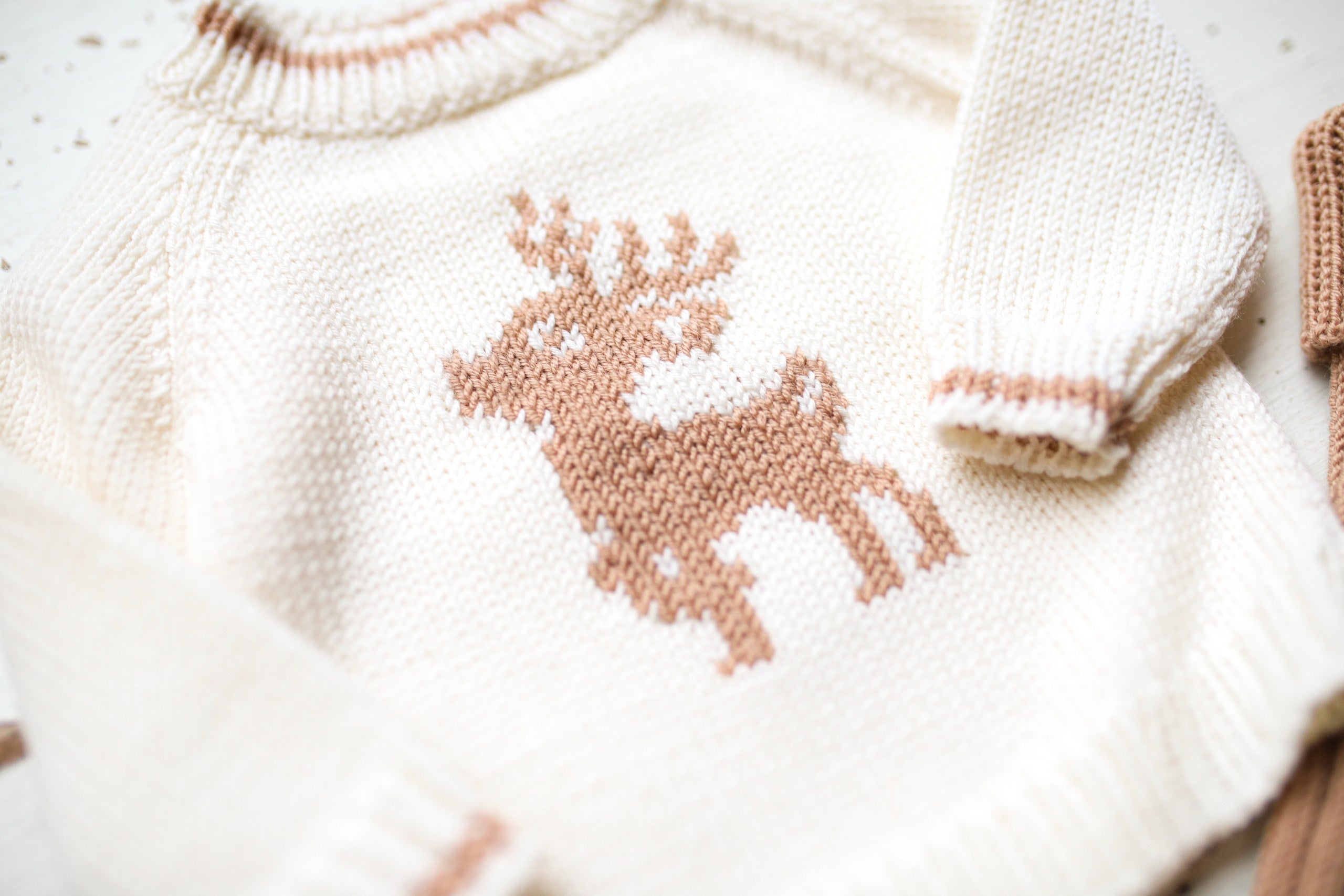 Knitted sweater with a reindeer pattern on a white background